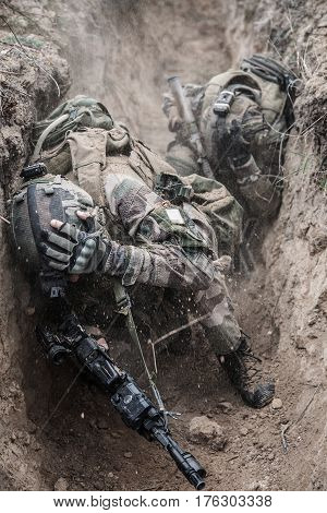 Paratroopers of french 1st Marine Infantry Parachute Regiment RPIMA are shelled in threnches, contused, covered with earth and soil