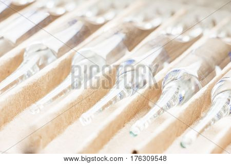 Row of transparent medical ampules in package. Close up
