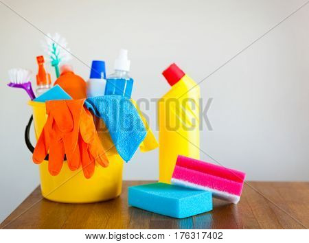 Basket With Cleaning Items On Blurry Background White Citchen. Cleaning Concept.