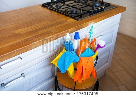 Basket With Cleaning Items On Blurry Background White Citchen. Cleaning Concept.