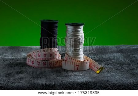 still life of spools of thread on a textil background fiber light abstract art bobbin
