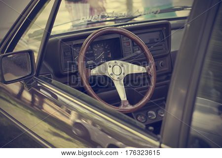 Interior of an old car with wooden steering wheel