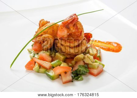 Fried Shrimps On Fried Vegetables On A White Plate