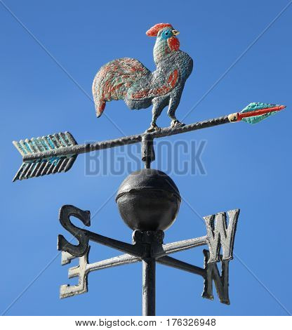 weathervaneto mark the wind with the arrow of the cardinal points and a rooster on