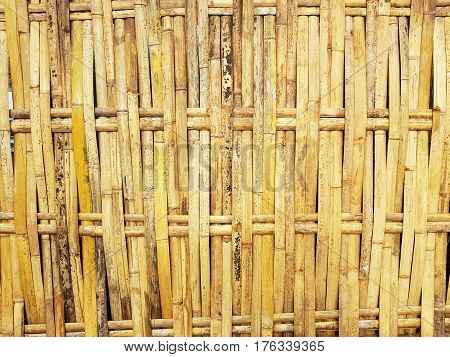 old grungy thai handcraft of bamboo weave pattern fence used for textuure background