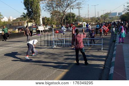 HYDERABAD,INDIA-FEBRUARY 19:People play badminton on Sundays in open road as Physical Literacy Days on February 19,2017 in Hyderabad,India.
