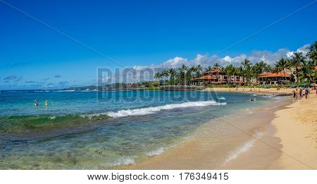 KAUAI, USA - MAR 3: Tourists and locals enjoy Poipu Beach on March 3, 2017 on Kauai, Hawaii. Poipu Beach is one of the most popular tourist areas on the island of Kauai and has many excellent hotels.