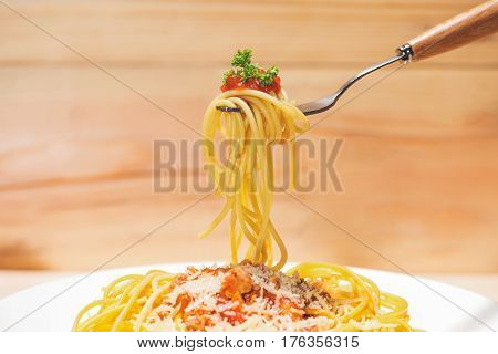 Close-up of asta spaghetti with tomato sauce olives and garnish. Italian food.