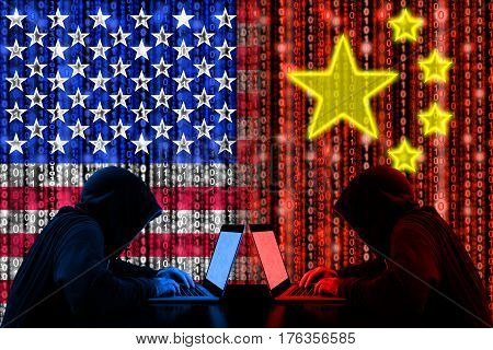 American hacker sitting opposite of a chinese hacker cyberwar concept in front of binary flags