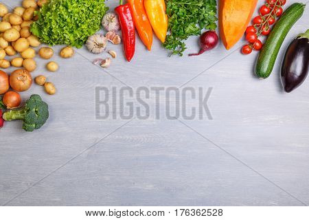 Fresh vegetables. Tomato, zucchini and eggplant. Potatoes, onion and garlic. Pepper, brocoli and salad. Pumpkin and parsley. Organic vegetables with copy space.