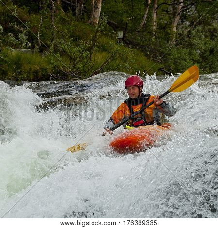 Kayaker in the waterfall in Norway Ula river
