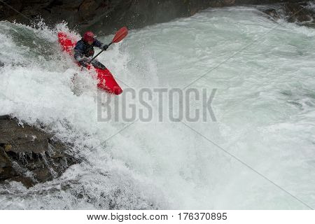 Kayaker in the waterfall in Norway Ula river