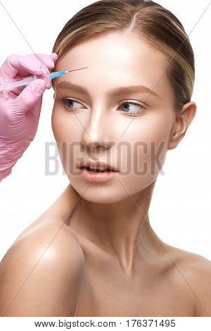 Young girl with a healthy skin and Nude makeup. Beautiful model on cosmetic procedures botox. Injections of beauty and youth. The beauty of the face