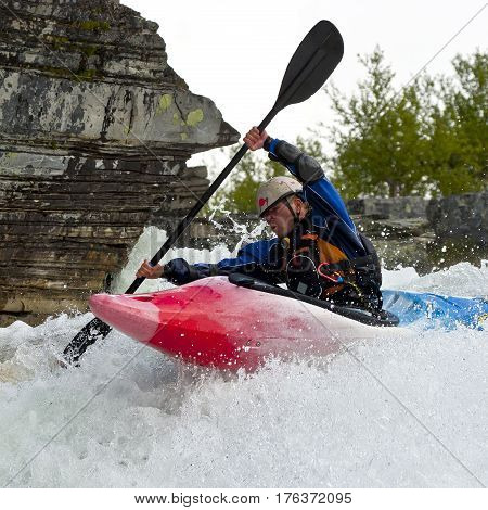 Kayaker in the waterfall in Norway Ula river