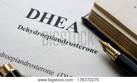 Dehydroepiandrosterone (DHEA) or androstenolone written on a page. Human hormones.