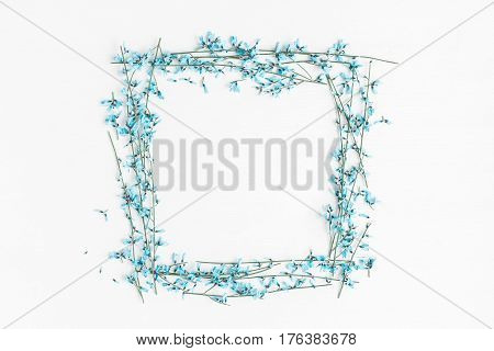 Flowers composition. Frame made of blue flowers on white background. Easter spring concept. Flat lay top view copy space