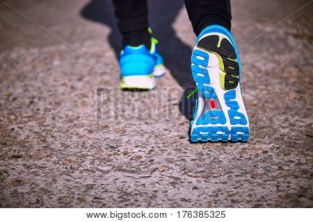 Running athlete during training outdoors in the summer on a sunny day.