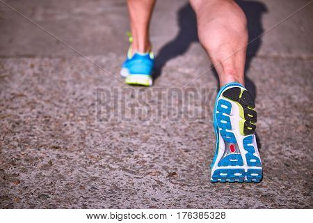 Running athlete during training outdoors in the summer on a sunny day.