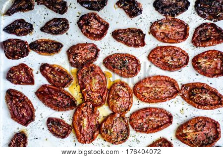 Sun dried tomatoes on a metal tray, top view