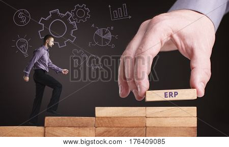 Business, Technology, Internet And Network Concept. Young Businessman Shows The Word: Erp