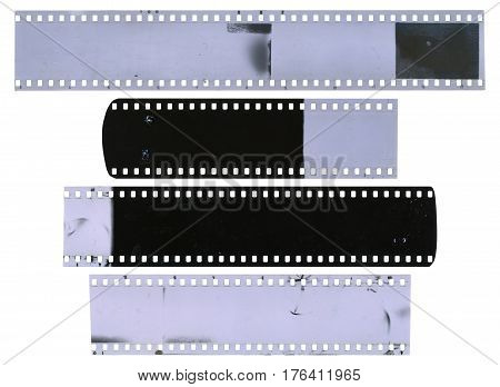 Old used dusty and scratched celluloid film strips isolated on white background