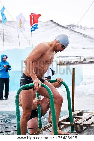 SAHYURTA IRKUTSK REGION RUSSIA - March 11.2017: Cup of Baikal. Winter Swimming Competitions. Swimmer after finish.