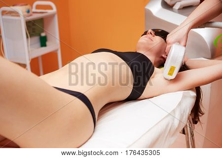 Beautician Removing Hair Of Young Woman with laser