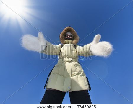 Girl dressed in warm jacket big white woolen mittens stretches out her hands to you. Siberia Russia Cold Frost