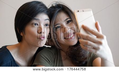 Two Happy Photogenic Asian Womans Talking Selfie With Phone