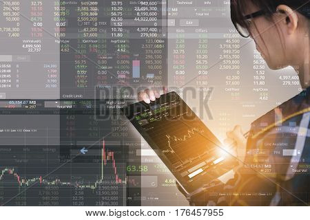 Double exposure of business woman with glasses in hipster shirts holding tablet for check stock market graph with flare light Business Trading concept