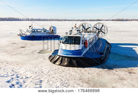 SAMARA RUSSIA - MARCH 11 2017: Passenger Hovercrafts on the ice of the frozen Volga river in Samara Russia