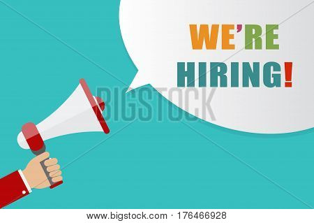 Hand holding Megaphone with speech bubble on blue background with words we're hiring vector illustration