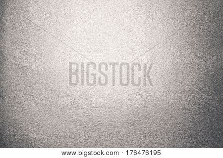 Background of silver paper with overflow and glare.