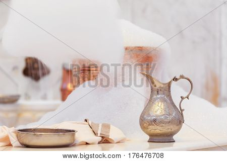 Making Soap Foam For Massage. Water Jar, Towel And Copper Bowl With Soap Foam In Turkish Hamam. Trad