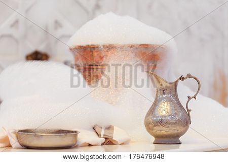 Water Jar, Towel And Copper Bowl With Soap Foam In Turkish Hamam. Traditional Interior Details