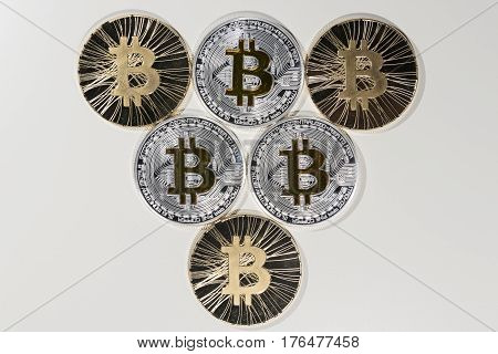 Shining metal BTC bitcoin coins on white background.