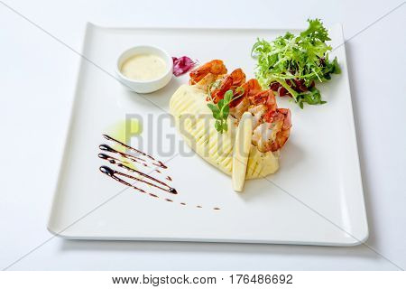 Fried Shrimps With Mashed Potatoes With Sauce On A White Plate Garnished With Fresh Lettuce. Stir Fr