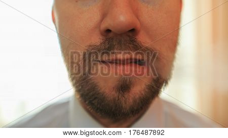 Young Funny White Businessman With Beard And Mustache Emits Puff Of Steam From The Electronic Cigare