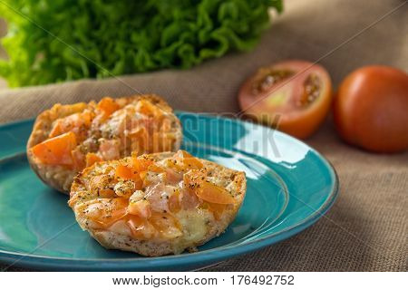 Toasted bread with tomato and melted cheese with herbs