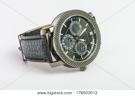 Black men's Quartz watch on a leather strap on a table on a white background