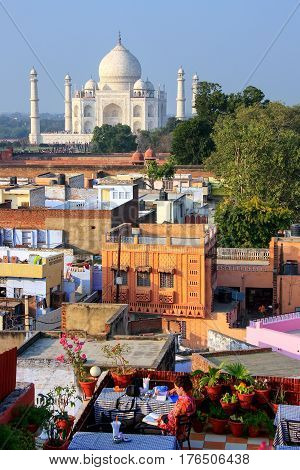 View of Taj Mahal from the rooftop restaurant in Taj Ganj neighborhood in Agra India. Taj Mahal was build in 1632 by Emperor Shah Jahan as a memorial for his second wife Mumtaz Mahal.