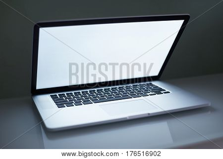 Laptop close abit with white copy space screen . Low Key lighting and selected focus.
