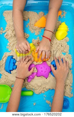 Childs Hand Close Up Playing Kinetic Sand