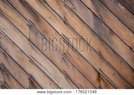A diagonal, wooden surface background pattern texture.