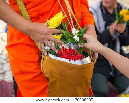 Offer sacrifice flowers to monk, Buddhist  religion