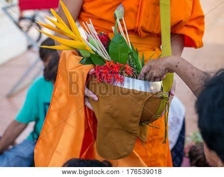 Offer sacrifice flowers to monk, Buddhist  religion