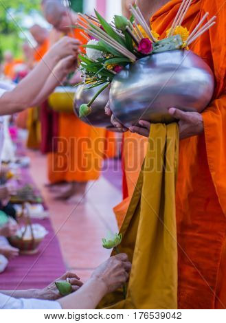 Offer sacrifice flowers to monk, Buddhist  religion