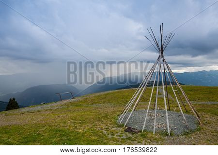 Typical American teepii on the hill before storm. Summer landscape in Gerlitzen Apls Austria.