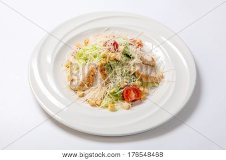 Caesar Salad With Chicken On A White Round Plate