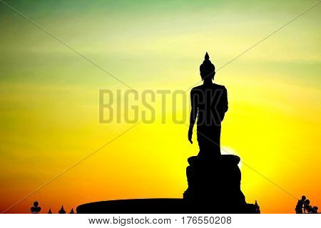 Sunset in Buddhist park in the Phutthamonthon district Buddhamonthon. Nakhon Pathom Province of Thailand. (Silhouette of Buddha)